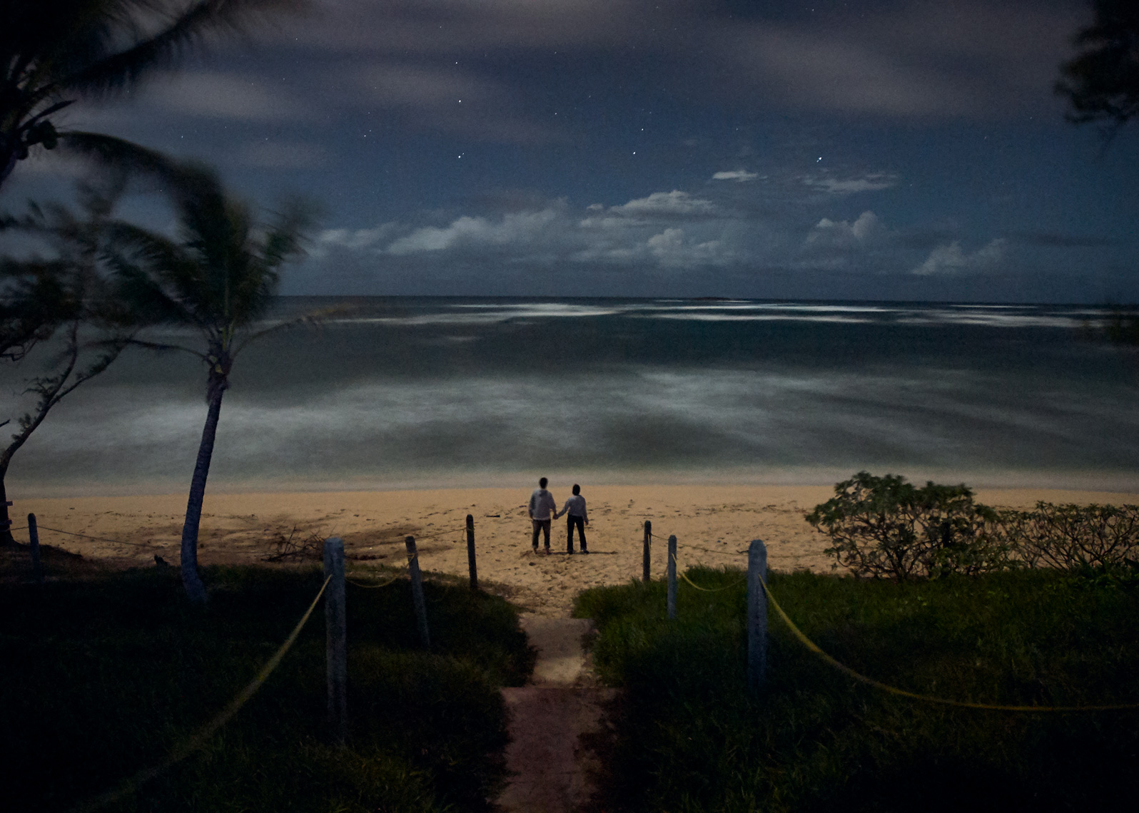 Landscape photo of couple on beach in Hawaii