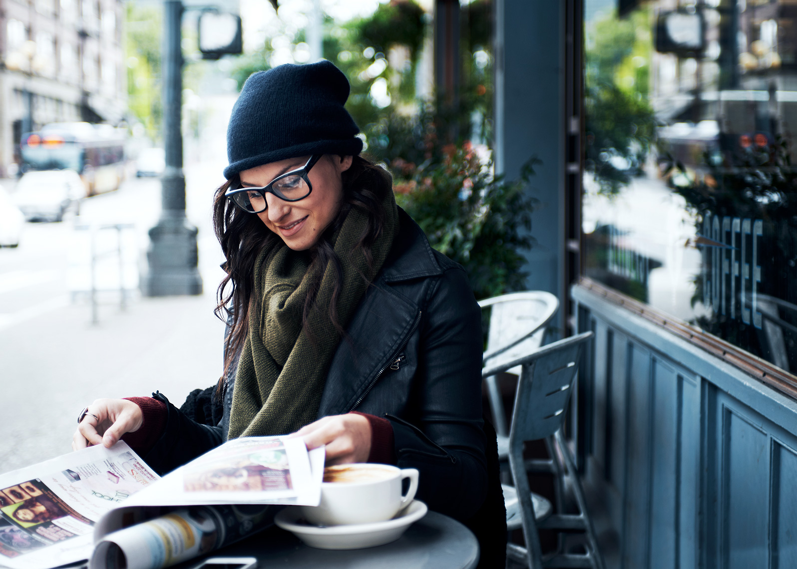 girl sits with coffee and paper in this seattle  lifestyle photoshoot