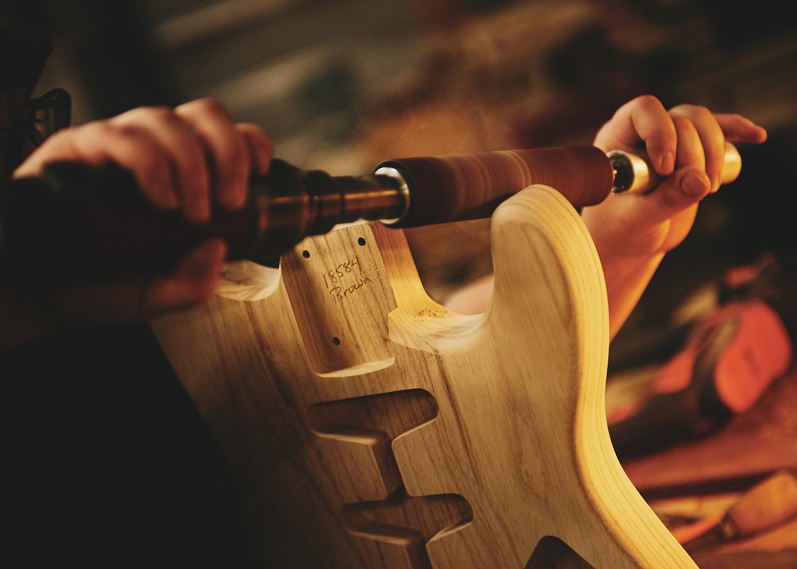 Final touches to body of custom guitar | Brand library photography