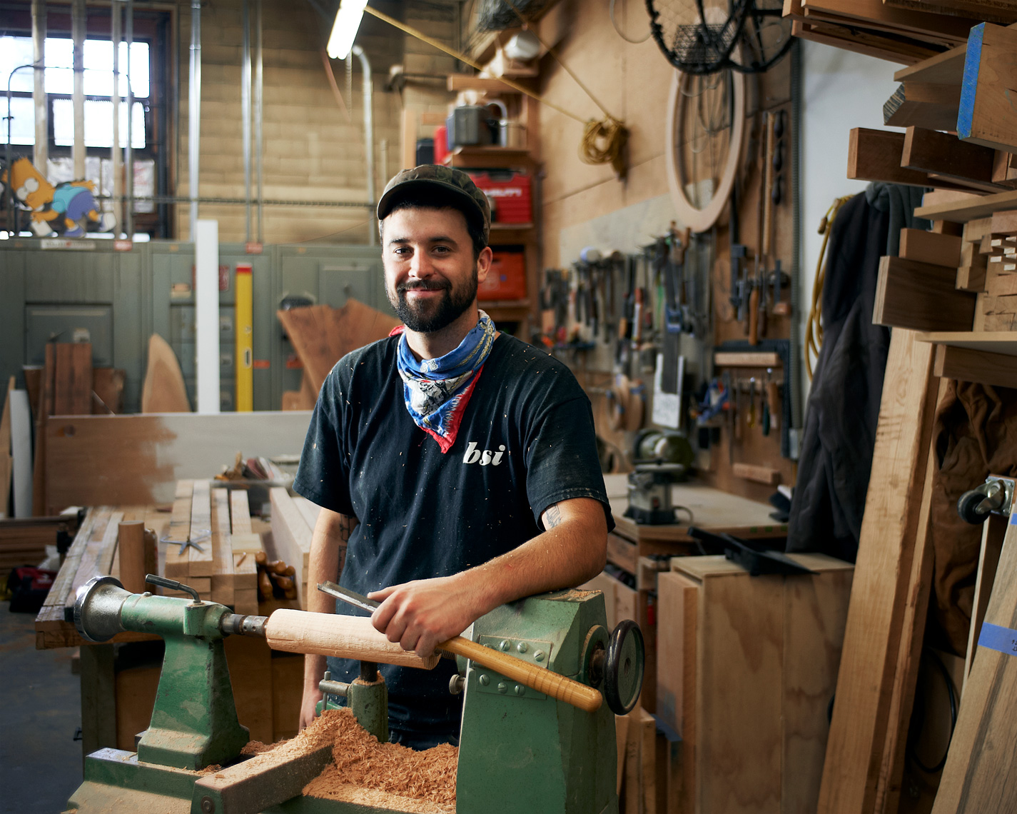 Woodworker poses among his tools for this workplace portrait