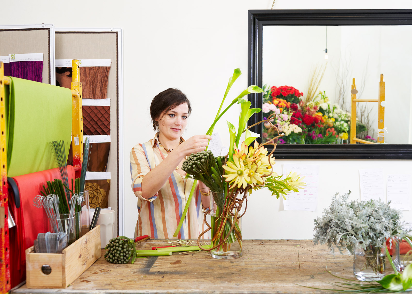 Woman arranges flowers for a brand shoot 