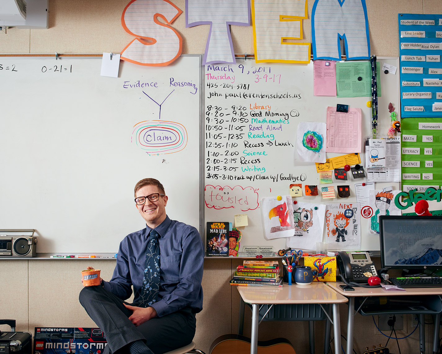 environmental portrait of teacher in his classroom