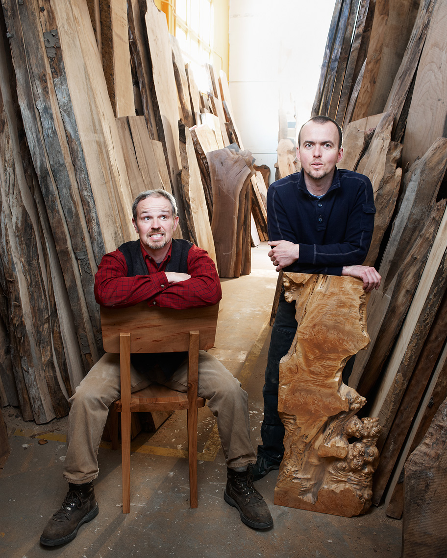 artist woodworkers pose with raw wood for their portrait